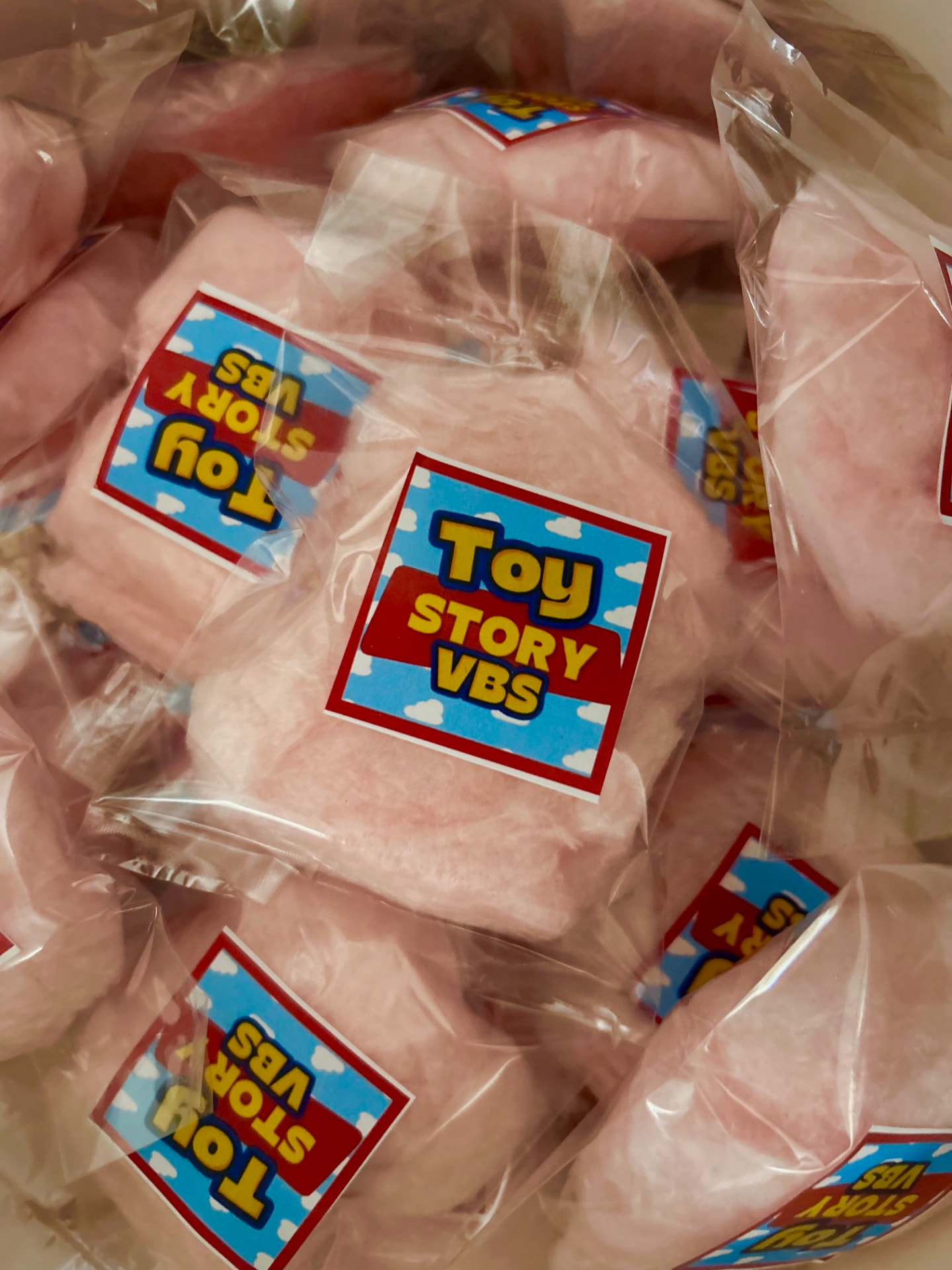 Individually packaged pink cotton candy puffs with custom Toy Story VBS branded labels