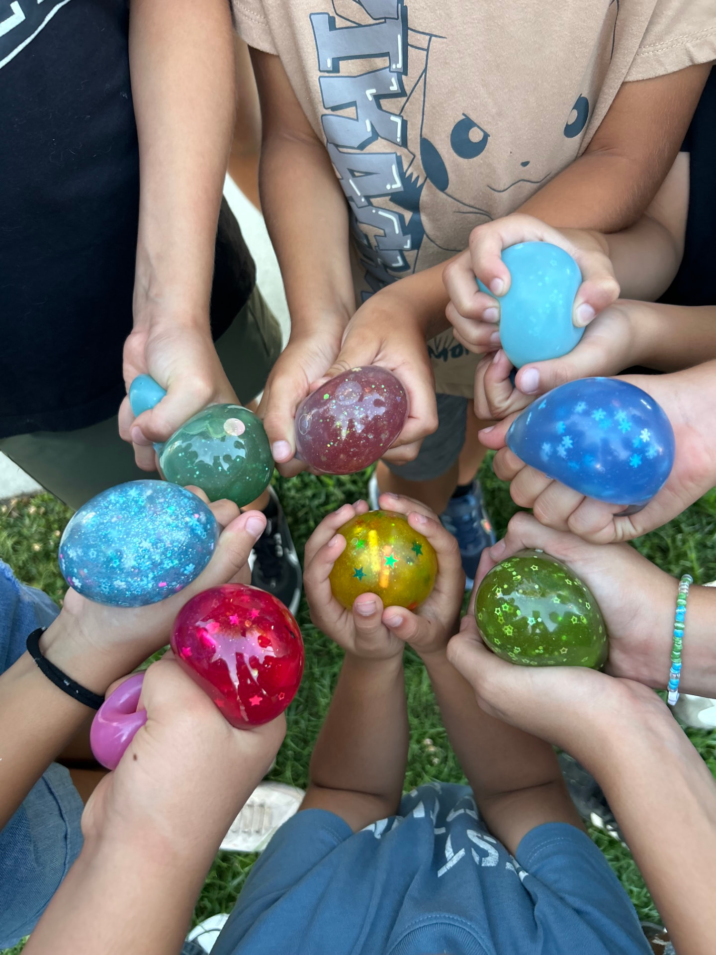Kids holding colorful squishy creations