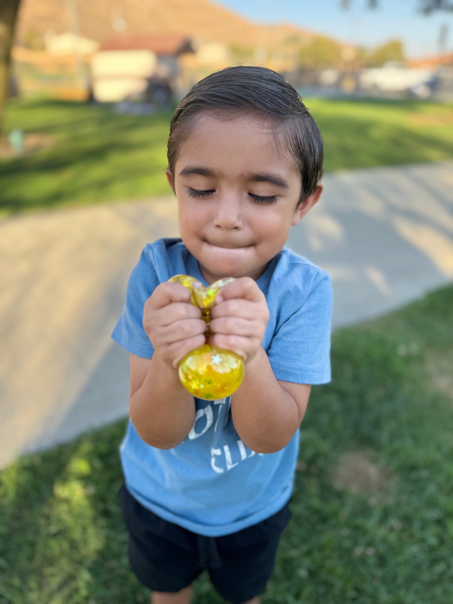 Child happily holding a personalized yellow squishy creation